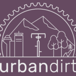 Image of the Boston skyline, a bike, trees, and mountains within a bike gear, over the words "urbandirt"