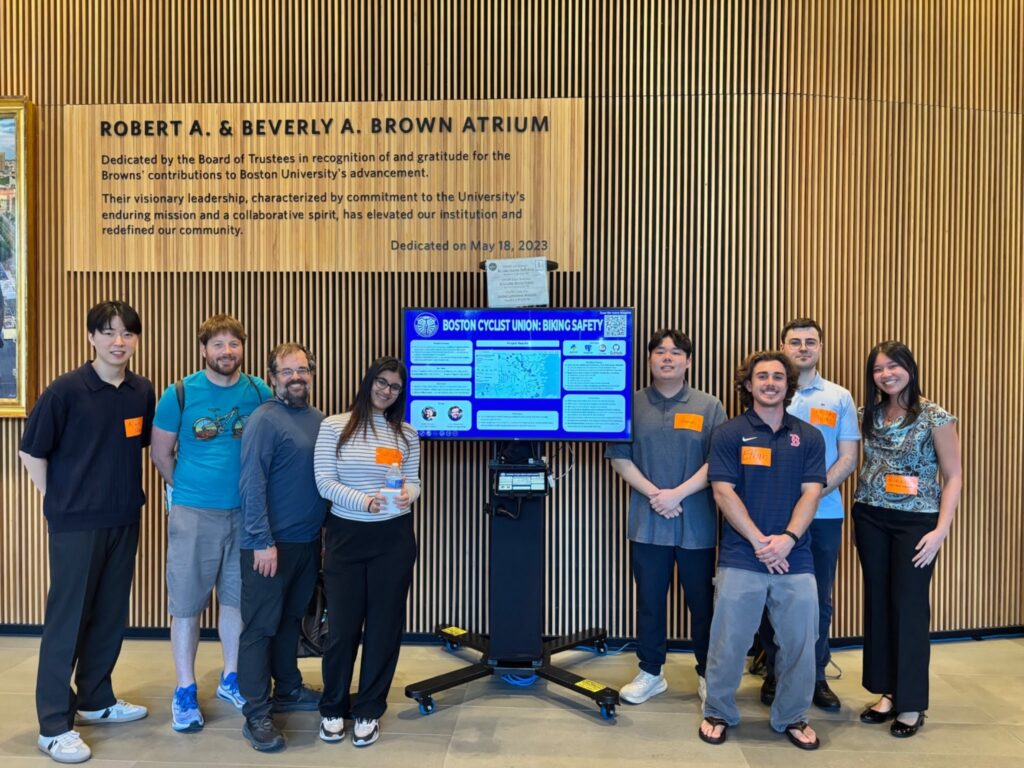 8 people on either side of a screen smiling, showing their work on the Crash Map