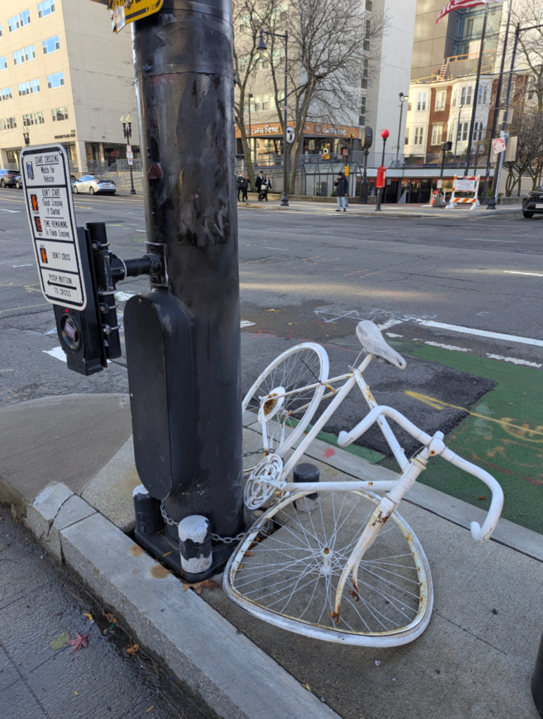 3 years later the same ghost bike is mangled with a crumpled front wheel after being hit by a driver on the sidewalk showing the lack of protection even at a deadly crash site
