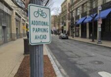 street sign on a city street showing bike parking ahead